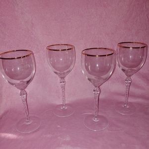 Set of 4 fine crystal with gold trim champagne/wine glasses.